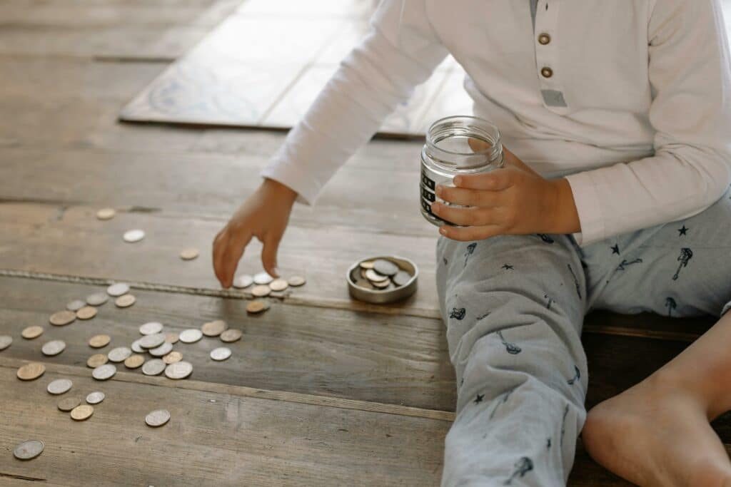 Someone counting coin money on the floor