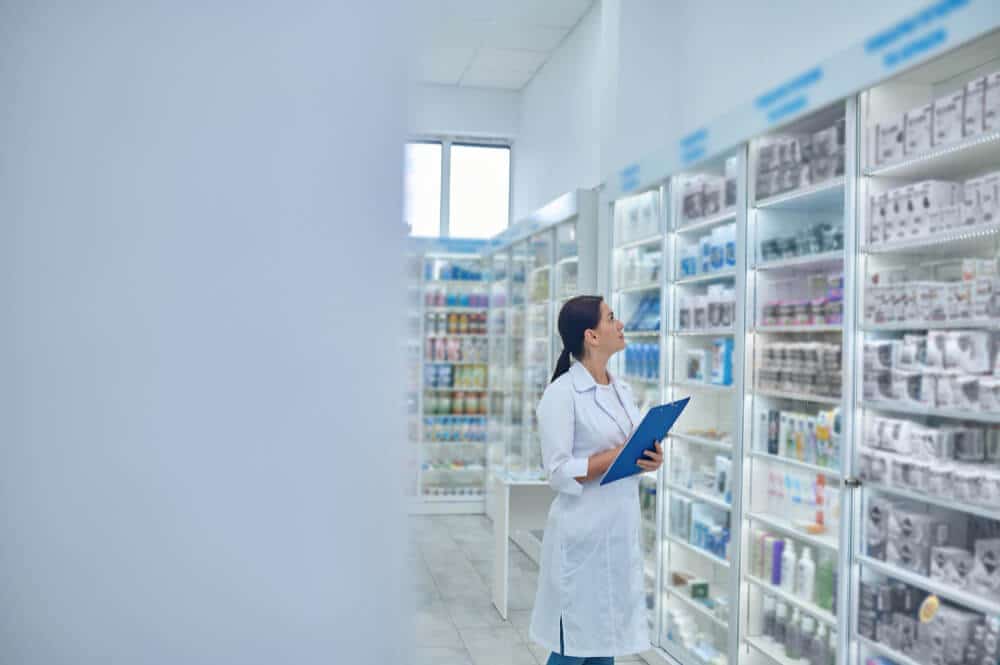 A pharmacist checking the list drugs within the store