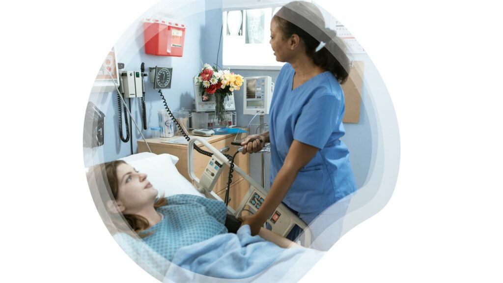 A nurse taking care of a bariatric patient on a bariatric bed.