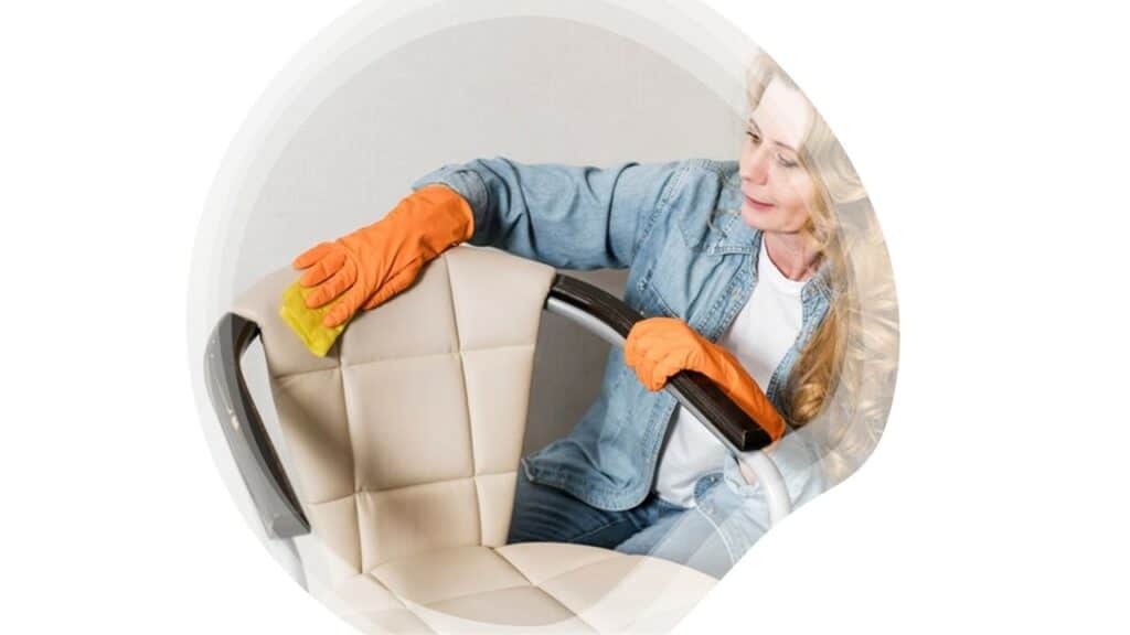A care worker cleaning seats