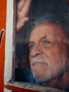 A dementia patient looking through the window