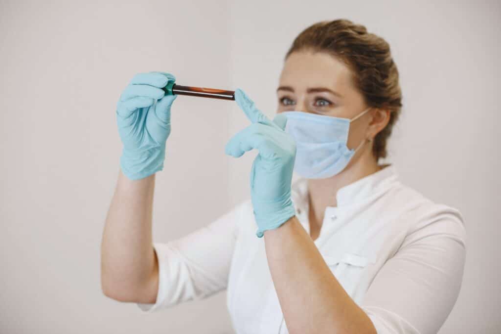 A nurse looking and examining blood sample