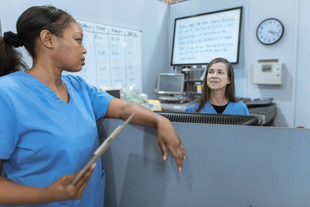 Two female nurses discussing within the clinic