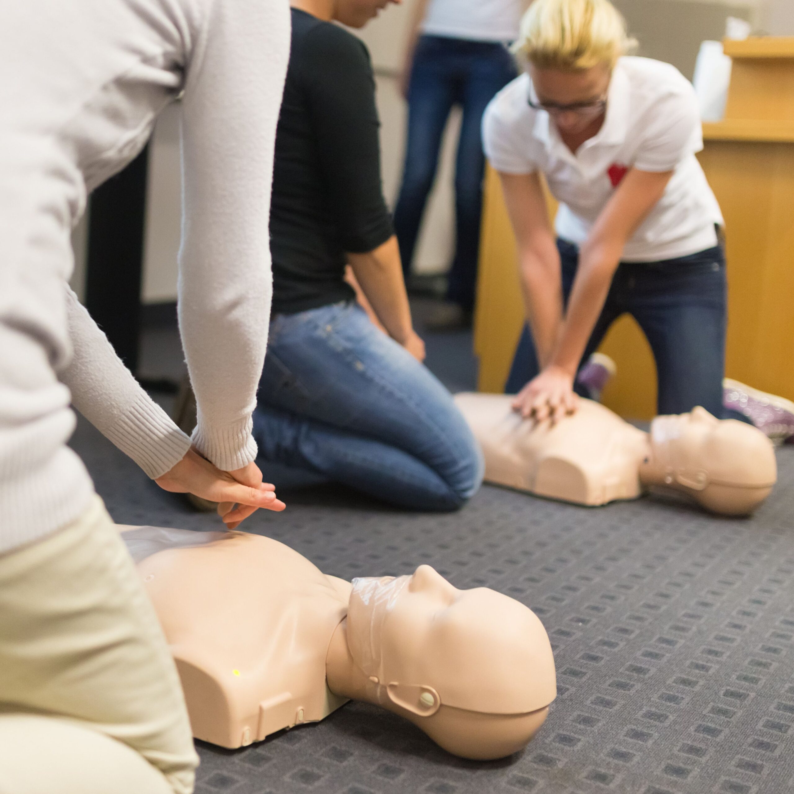 Learners practising CPR on a manikin during a first aid training session in Stoke-on-Trent